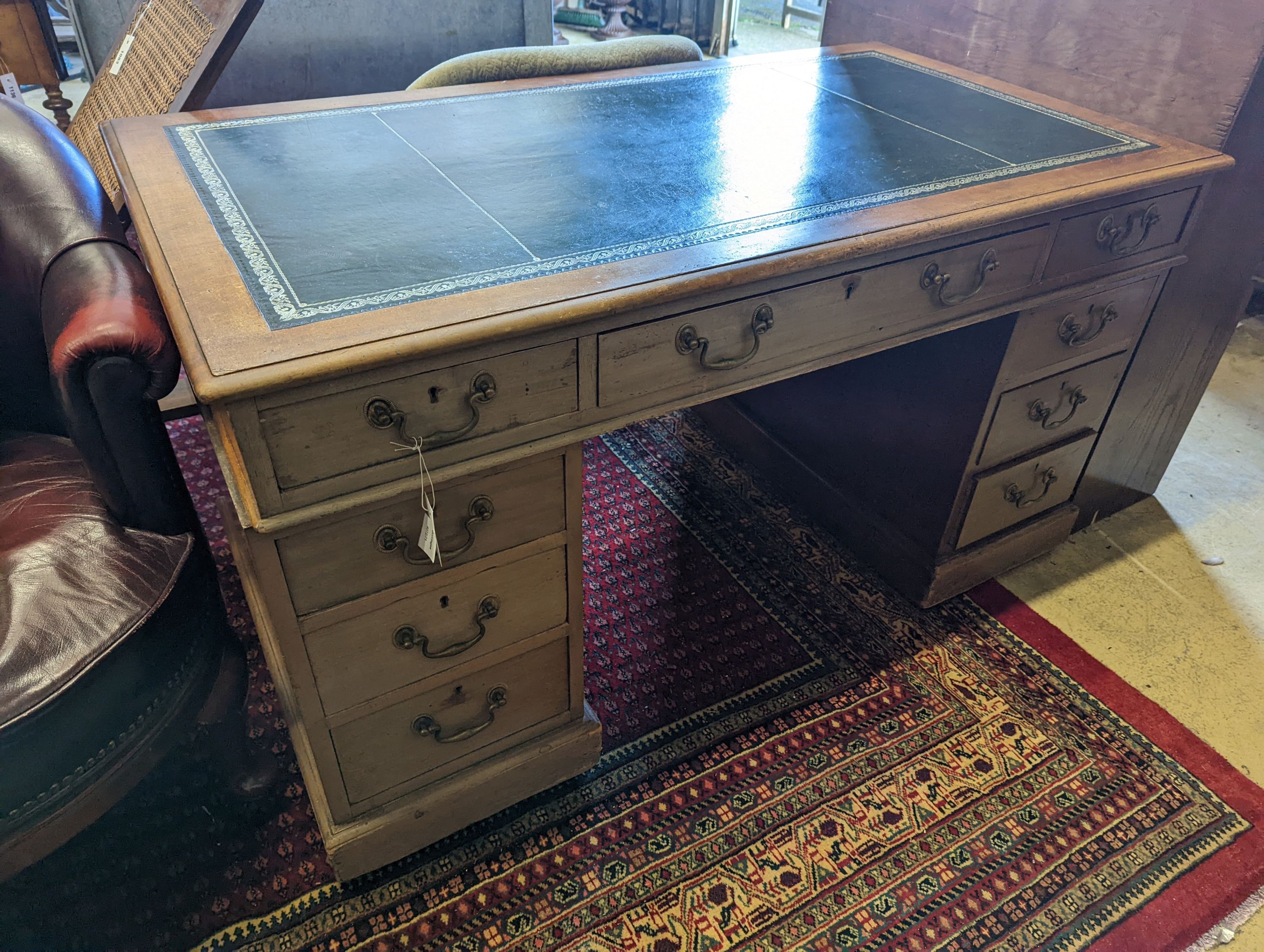 An Edwardian faded mahogany pedestal desk, stamped T. Willson, Great Queen Street, London, length 136cm, depth 76cm, height 76cm